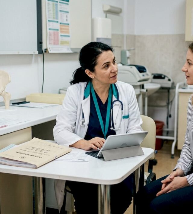 Medic și pacient discută în cabinet, analizând împreună rezultatele și planul de tratament.