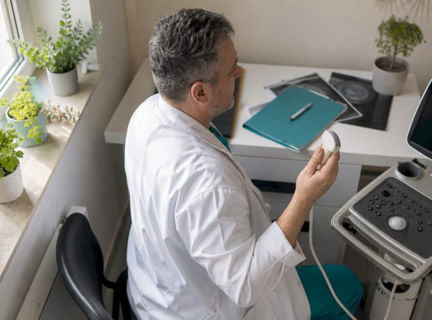 Tehnicianul medical realizează investigații cu ajutorul ecografului.